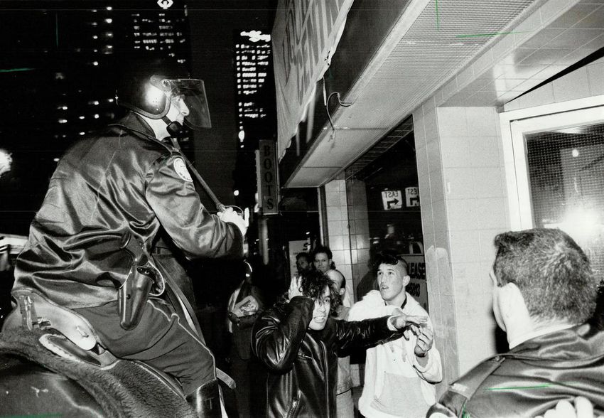 A mounted Metro police officer engages with protestors during the Yonge Street Riot of May 5, 1992.