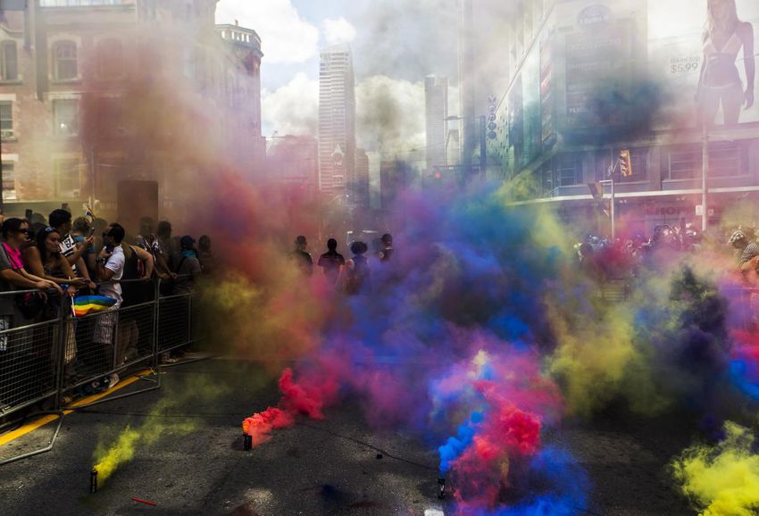 Members of the Black Lives Matters movement stand in smoke from smoke grenades at the 2016 Pride parade.